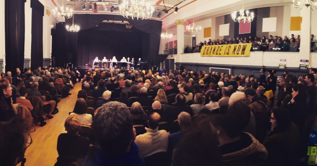 Photo of packed audience inside the Stroud Sub Rooms during Climate Change Hustings